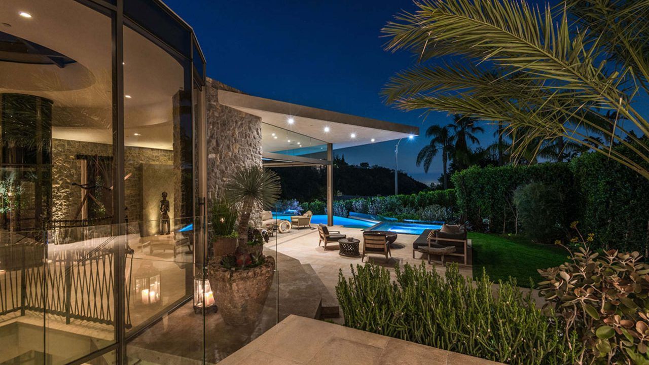 Beautiful view of outside space of a home with pool and patio - history of modern architecture design - Dean Larkin Design