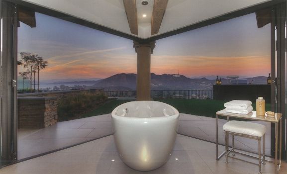 bathtub in front of glass walls facing a sunset | features of contemporary architecture design | Dean Larkin Design