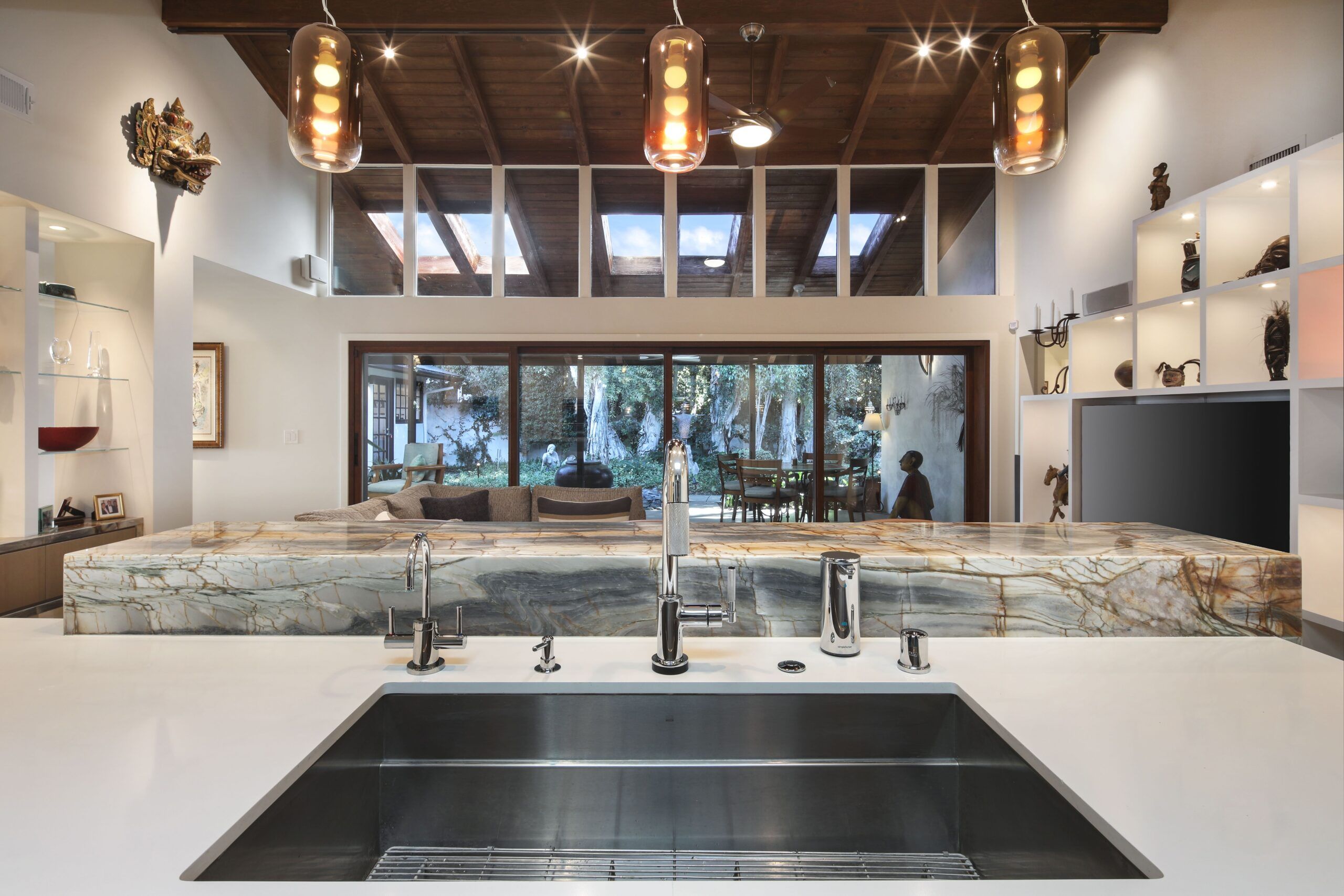 Kitchen with Picasso stone looking out across great room to the outdoor space | River Lane Project | Design Trends in California Architecture Projects | Dean Larkin Design