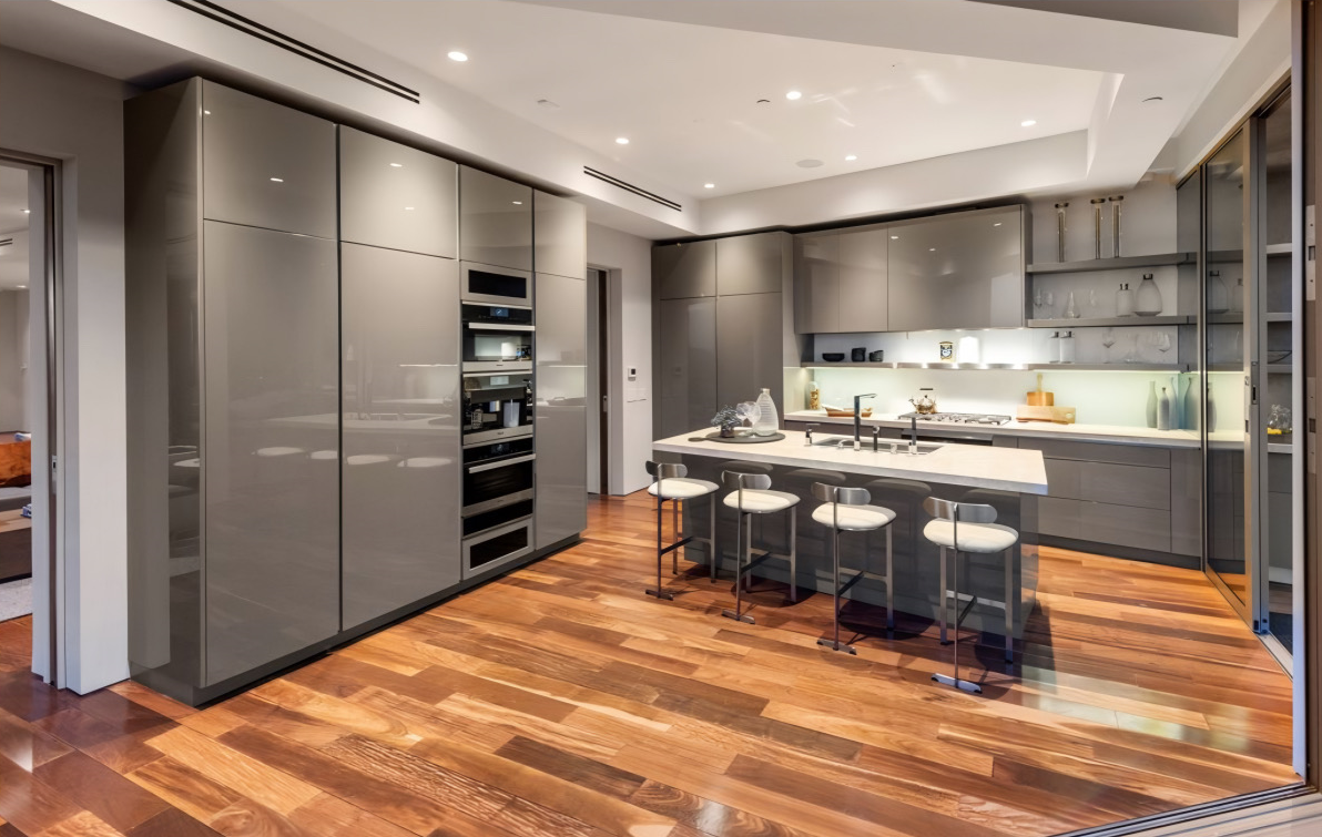 kitchen with gray appliances and cabinets and wood floors- Tigertail Project - kitchen design's evolution from function to luxury - Dean Larkin Design