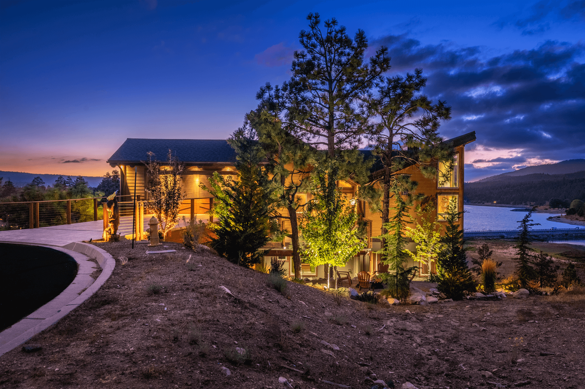 Eagle Lake Project - Nighttime view of side of cabin and lake - Dean Larkin Design