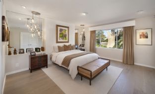 Primary bedroom with light walls and pendant lights over nightstand at River Lane Project  |flex spaces in architecture design | Dean Larkin Design