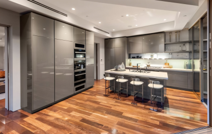 kitchen with gray appliances and cabinets and wood floors- Tigertail Project - Dean Larkin Design