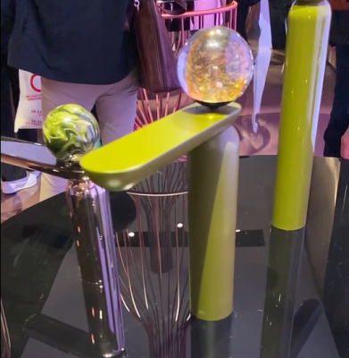 GRAFF faucets with columnular bases, flattened spouts brightly colored with marble type large spheres on top - new design trends at Slone del Mobile 2023 - Dean Larkin Design