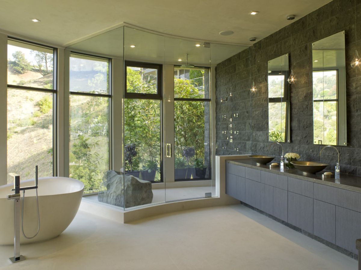 Bathroom with wall of windows and a rock seat in the shower | Indoor/Outdoor Residential Design | Dean Larkin Design