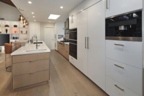 white cabinets and white hidden fridge - river lane project - flex spaces in architecture design - dean larkin design