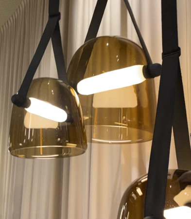 brown toned opaque globes with light rods held on leather straps - New lighting trend at Salone del Mobile 2023- Dean Larkin Design