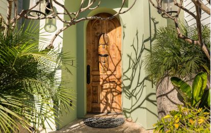 Entryway with carved wooden door of Grand Canal Project - Dean Larkin Design